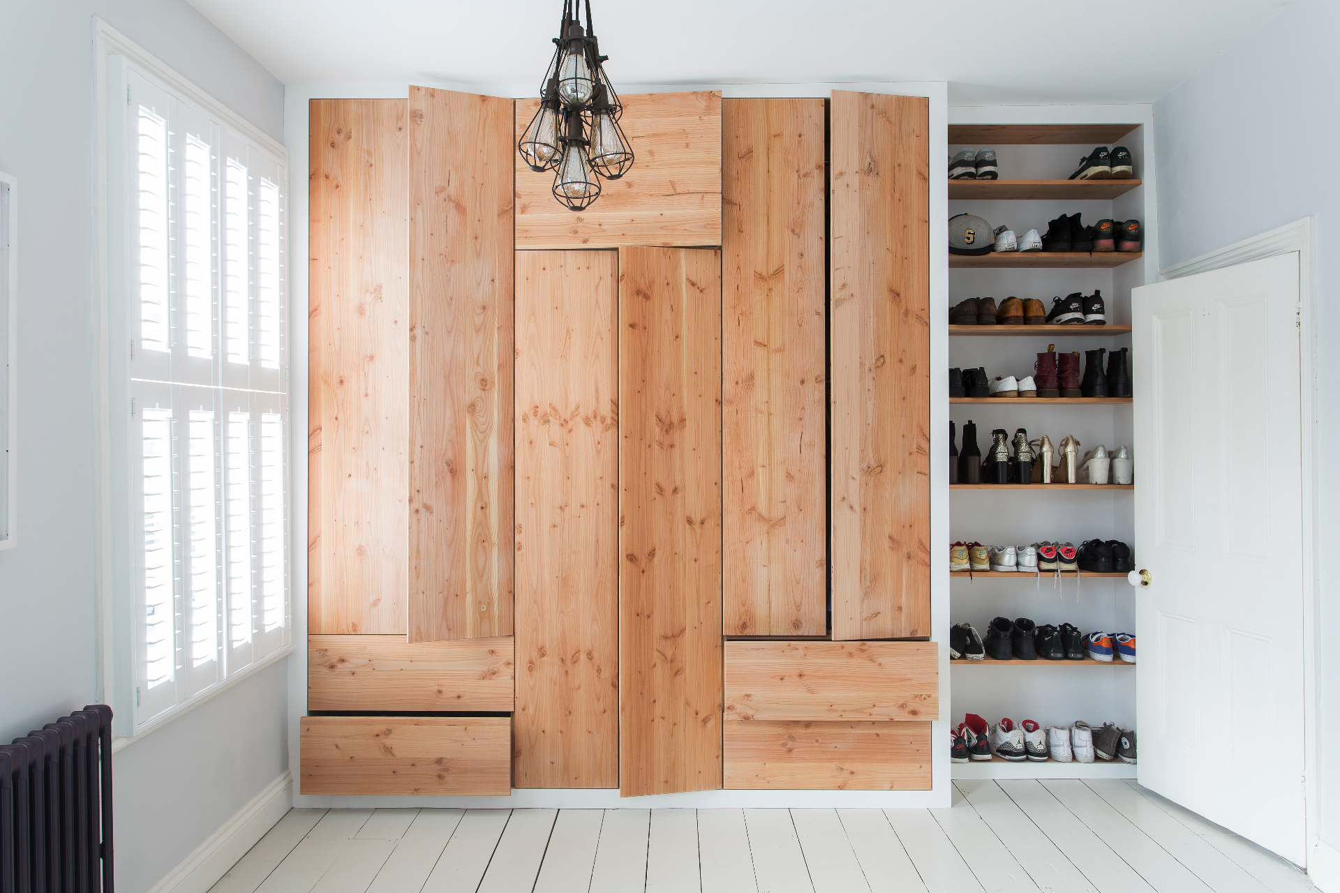 Bespoke fitted oak joinery in a sunlit hallway with skylight
